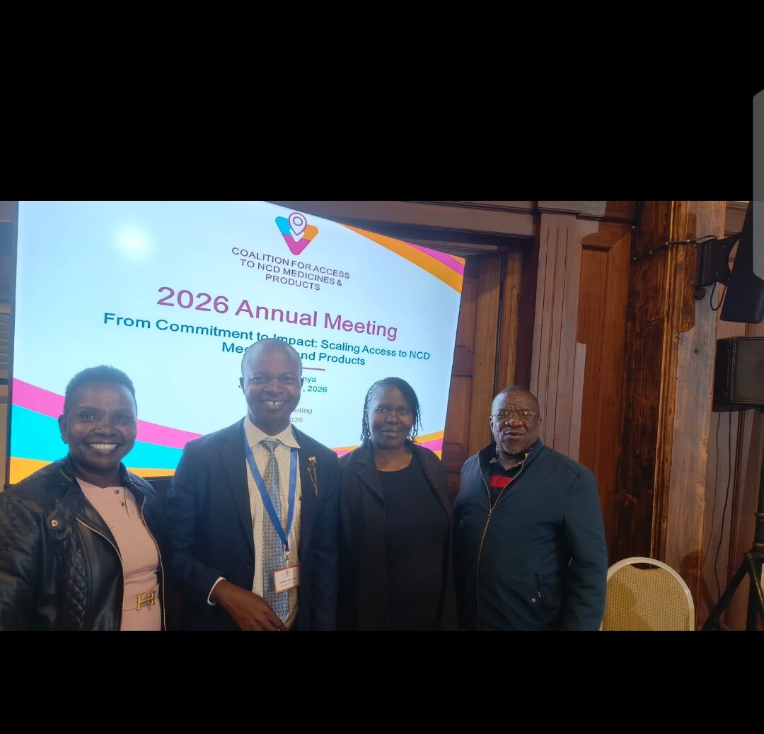 Meeting participants beside the Coalition banner